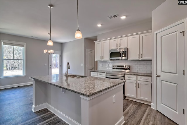 689 W Columbia Ave, Batesburg, SC 29006 - kitchen with stainless steel appliances, dark wood-style floors, white cabinetry, a kitchen island with sink, and backsplash