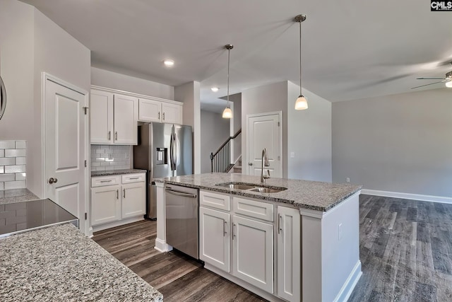 689 W Columbia Ave, Batesburg, SC 29006 - kitchen featuring appliances with stainless steel finishes, dark wood-style floors, white cabinets, a ceiling fan, and an island with sink