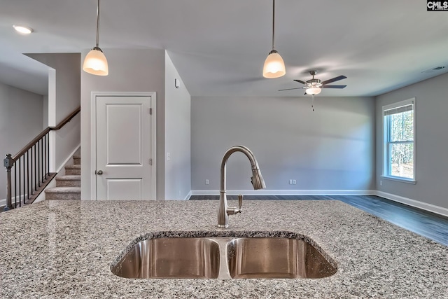 689 W Columbia Ave, Batesburg, SC 29006 - kitchen with stone counters, a ceiling fan, hanging light fixtures, and wood finished floors