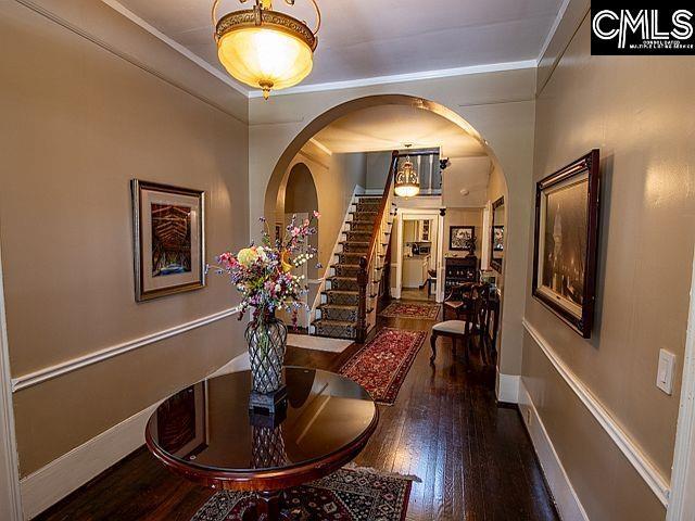1220 Calhoun St, Newberry, SC 29108 - hall with wood finished floors, stairs, arched walkways, and ornamental molding