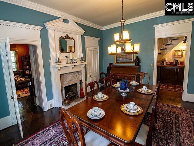 1220 Calhoun St, Newberry, SC 29108 - dining space featuring wood finished floors, crown molding, and a premium fireplace