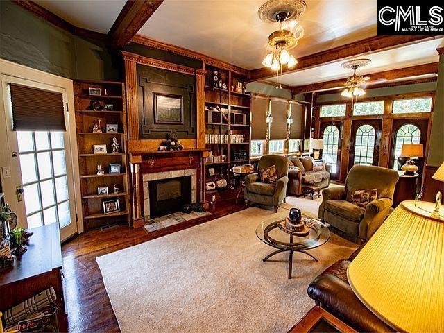 1220 Calhoun St, Newberry, SC 29108 - living area with beam ceiling, a fireplace with flush hearth, wood finished floors, and built in features