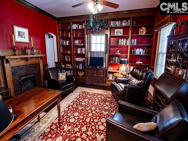 1220 Calhoun St, Newberry, SC 29108 - living room featuring a ceiling fan, a fireplace, and built in shelves