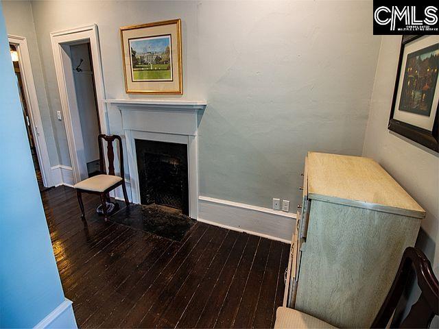 1220 Calhoun St, Newberry, SC 29108 - living room featuring wood-type flooring and a fireplace with flush hearth