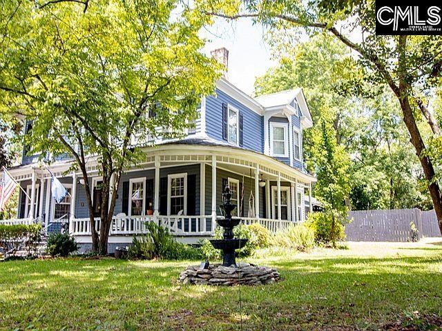 1220 Calhoun St, Newberry, SC 29108 - back of property featuring covered porch and a yard