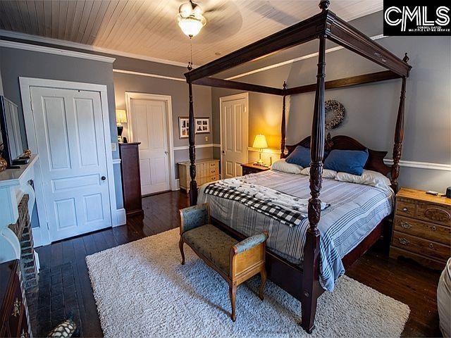 1220 Calhoun St, Newberry, SC 29108 - bedroom with hardwood / wood-style floors and crown molding