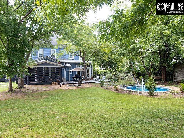 1220 Calhoun St, Newberry, SC 29108 - view of grassy yard featuring a patio and an outdoor pool