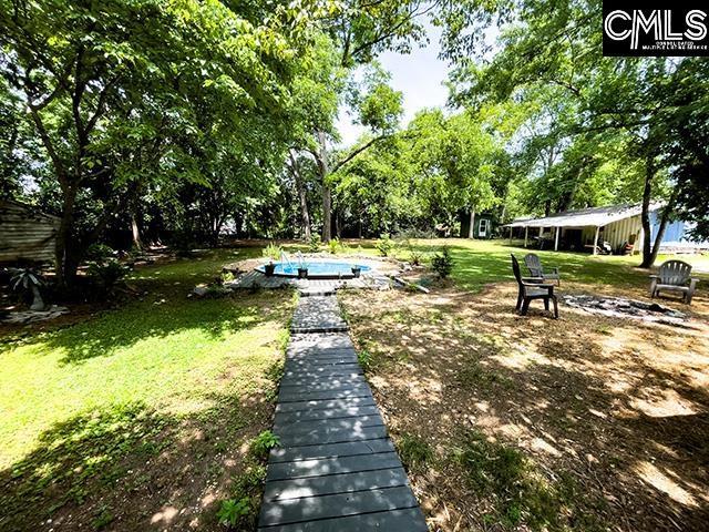1220 Calhoun St, Newberry, SC 29108 - view of home's community featuring a yard and view of wooded area