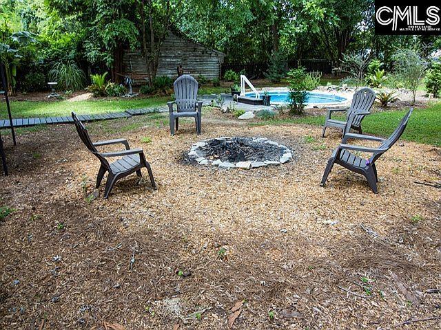 1220 Calhoun St, Newberry, SC 29108 - view of yard with an outdoor fire pit and an outdoor pool