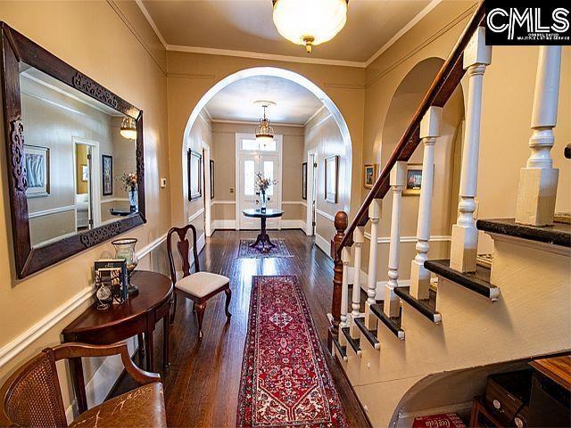 1220 Calhoun St, Newberry, SC 29108 - entryway with ornamental molding, stairs, arched walkways, and wood finished floors