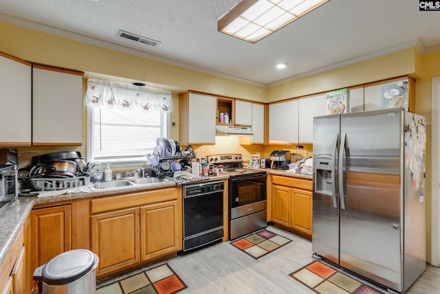 2161 Tanglewood Rd, Sumter, SC 29154 - kitchen featuring stainless steel appliances, crown molding, under cabinet range hood, a textured ceiling, and light wood-type flooring