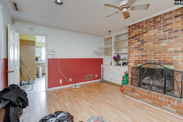 2161 Tanglewood Rd, Sumter, SC 29154 - unfurnished living room with crown molding, a ceiling fan, a brick fireplace, and light wood-style flooring