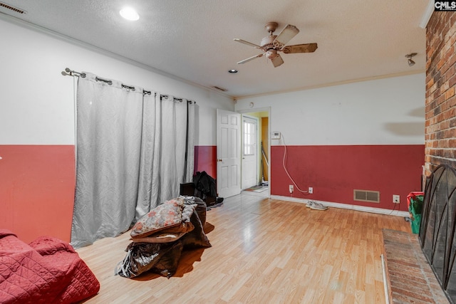 2161 Tanglewood Rd, Sumter, SC 29154 - living room with ceiling fan, wood finished floors, a textured ceiling, recessed lighting, and a fireplace