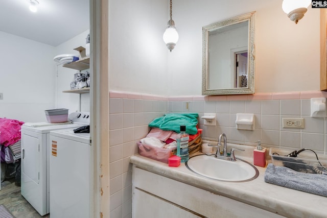 2161 Tanglewood Rd, Sumter, SC 29154 - bathroom with separate washer and dryer, vanity, tile walls, and wainscoting