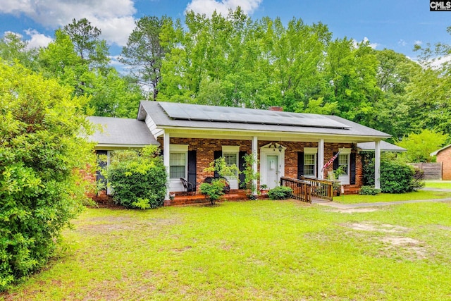 2161 Tanglewood Rd, Sumter, SC 29154 - view of front facade with a porch, a front yard, brick siding, and a chimney