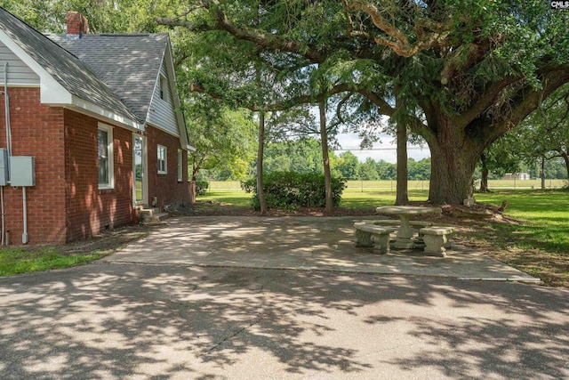 318 Summerland Ave, Batesburg, SC 29006 - view of home's exterior with brick siding, a shingled roof, a chimney, and entry steps