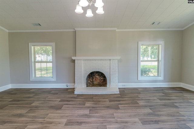 318 Summerland Ave, Batesburg, SC 29006 - unfurnished living room featuring a chandelier, plenty of natural light, wood finished floors, and ornamental molding