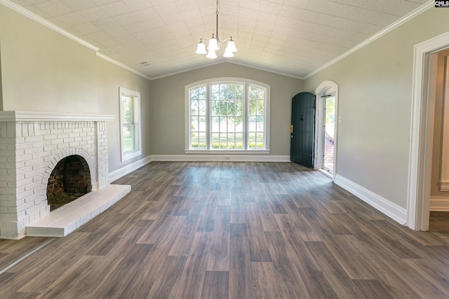 318 Summerland Ave, Batesburg, SC 29006 - unfurnished living room featuring a chandelier, dark wood-type flooring, a brick fireplace, crown molding, and arched walkways