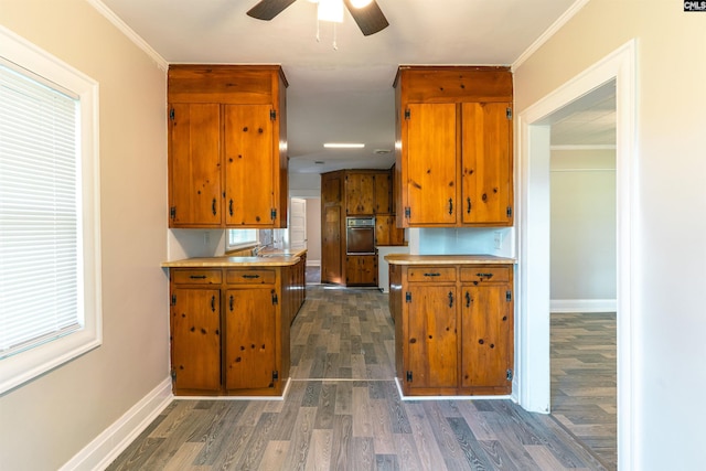 318 Summerland Ave, Batesburg, SC 29006 - kitchen featuring oven, brown cabinetry, dark wood-type flooring, light countertops, and a ceiling fan