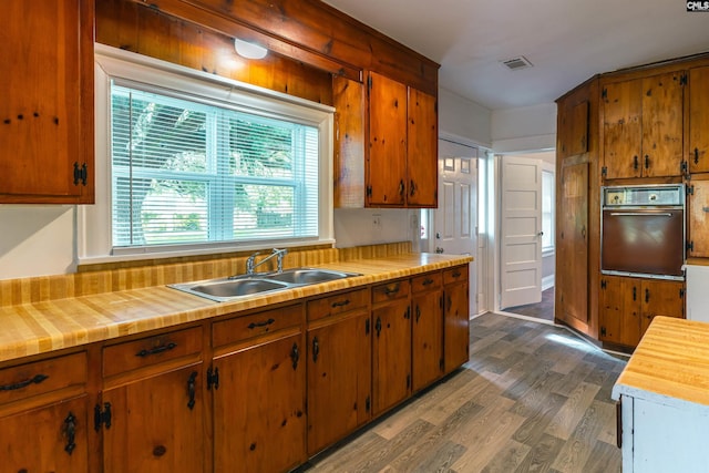318 Summerland Ave, Batesburg, SC 29006 - kitchen featuring wall oven, wood finished floors, brown cabinets, and wood counters