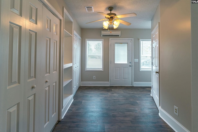 318 Summerland Ave, Batesburg, SC 29006 - entrance foyer featuring a wall mounted AC, a ceiling fan, a textured ceiling, and dark wood-type flooring