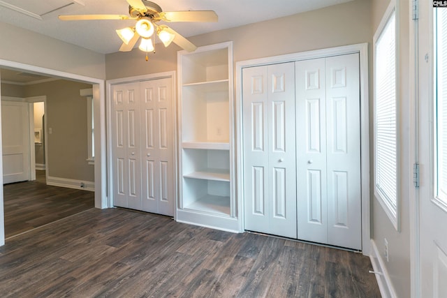 318 Summerland Ave, Batesburg, SC 29006 - unfurnished bedroom featuring two closets, dark wood finished floors, and ceiling fan