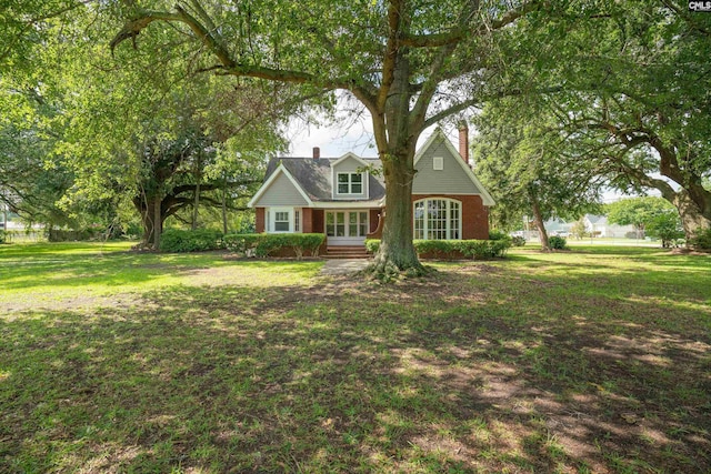 318 Summerland Ave, Batesburg, SC 29006 - view of front of property with a chimney, a front lawn, brick siding, and french doors
