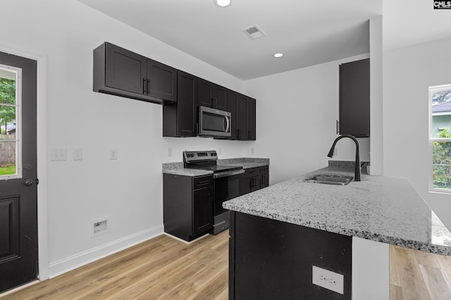 3723 Hoyt St, Columbia, SC 29223 - kitchen featuring stainless steel appliances, dark cabinetry, light wood finished floors, plenty of natural light, and recessed lighting