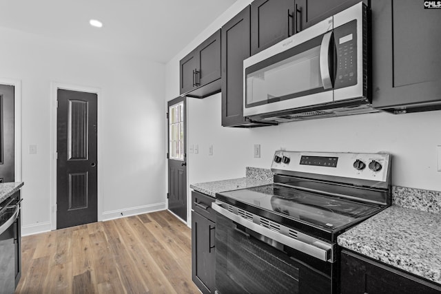 3723 Hoyt St, Columbia, SC 29223 - kitchen with stainless steel appliances, light wood-style flooring, dark cabinetry, light stone counters, and recessed lighting