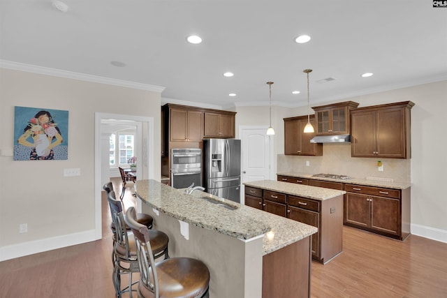 769 Broad Leaf Rd, Elgin, SC 29045 - kitchen featuring appliances with stainless steel finishes, a center island with sink, under cabinet range hood, light wood-type flooring, and recessed lighting