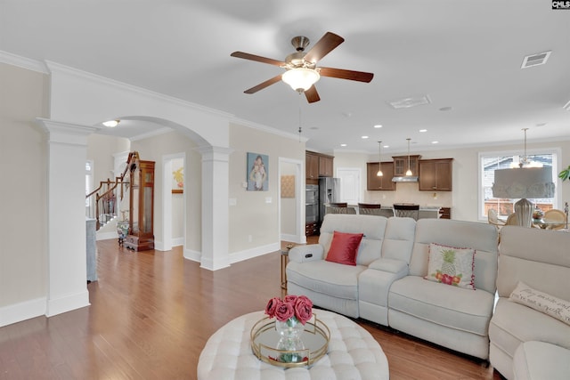 769 Broad Leaf Rd, Elgin, SC 29045 - living room featuring a ceiling fan, decorative columns, arched walkways, wood finished floors, and crown molding