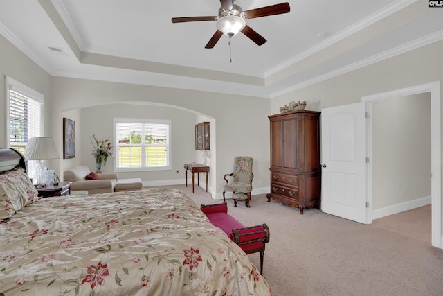 769 Broad Leaf Rd, Elgin, SC 29045 - bedroom featuring light carpet, multiple windows, a tray ceiling, arched walkways, and crown molding
