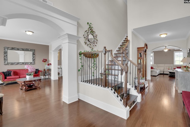 769 Broad Leaf Rd, Elgin, SC 29045 - foyer entrance with ornate columns, arched walkways, wood finished floors, stairs, and ornamental molding