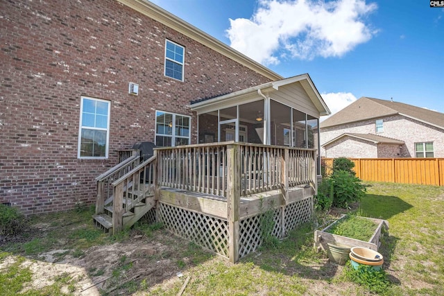 769 Broad Leaf Rd, Elgin, SC 29045 - rear view of house with a sunroom, a wooden deck, and brick siding