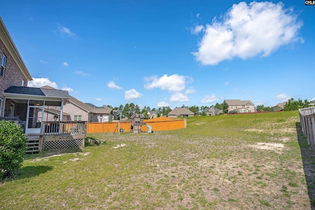 769 Broad Leaf Rd, Elgin, SC 29045 - fenced backyard with a sunroom, a residential view, a deck, and a playground