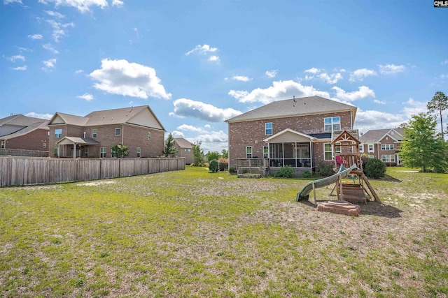 769 Broad Leaf Rd, Elgin, SC 29045 - rear view of house with brick siding, a sunroom, a playground, and a residential view