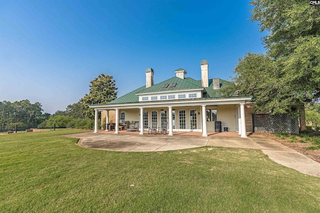 769 Broad Leaf Rd, Elgin, SC 29045 - back of property featuring a chimney, a lawn, a standing seam roof, a metal roof, and a patio