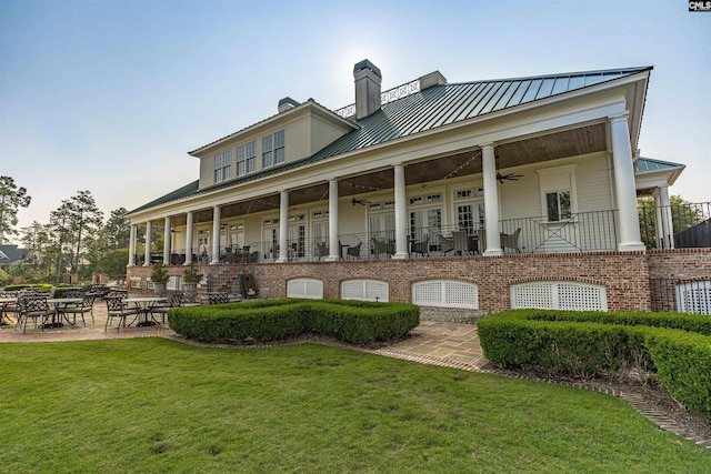 769 Broad Leaf Rd, Elgin, SC 29045 - back of property featuring a ceiling fan, a yard, a chimney, a standing seam roof, and a metal roof