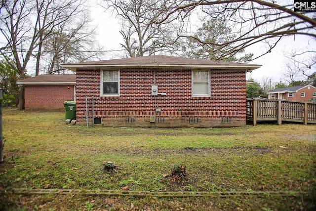 113 Brookland Cir, Columbia, SC 29204 - view of side of home with crawl space, a lawn, brick siding, and a wooden deck