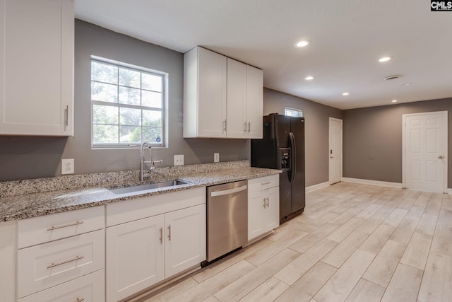 105 Garmony Cir, Columbia, SC 29212 - kitchen featuring dishwasher, black fridge, recessed lighting, white cabinets, and light stone counters