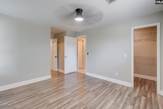 105 Garmony Cir, Columbia, SC 29212 - unfurnished bedroom with light wood finished floors, a spacious closet, a closet, and ceiling fan