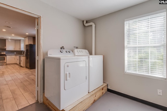105 Garmony Cir, Columbia, SC 29212 - laundry area with washing machine and clothes dryer, plenty of natural light, and recessed lighting