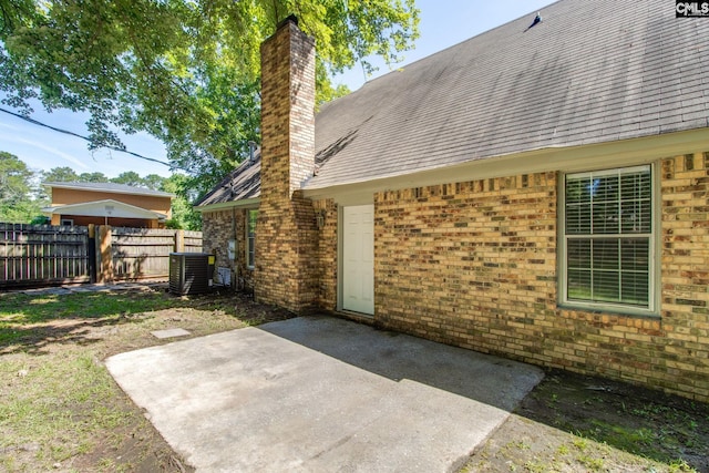 105 Garmony Cir, Columbia, SC 29212 - rear view of property featuring a chimney, brick siding, a patio, and roof with shingles