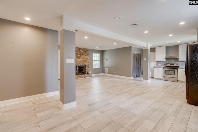105 Garmony Cir, Columbia, SC 29212 - unfurnished living room featuring light wood-style floors, a brick fireplace, and recessed lighting