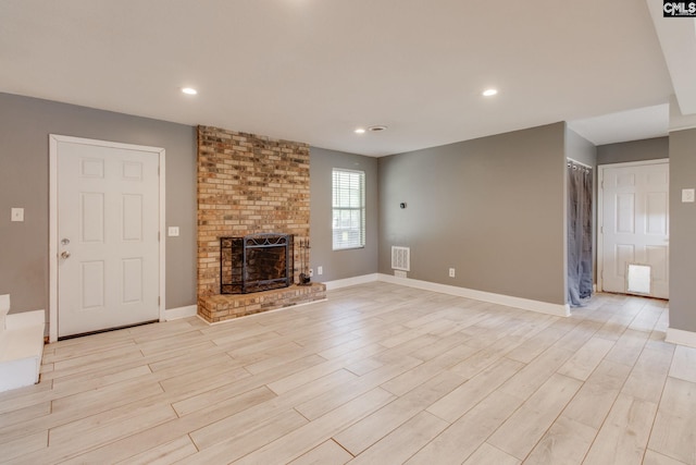 105 Garmony Cir, Columbia, SC 29212 - unfurnished living room with a fireplace, light wood-type flooring, and recessed lighting