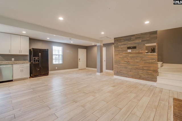 105 Garmony Cir, Columbia, SC 29212 - unfurnished living room featuring recessed lighting, wooden walls, and light wood-style floors