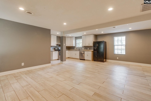 105 Garmony Cir, Columbia, SC 29212 - kitchen with stainless steel appliances, open floor plan, recessed lighting, white cabinetry, and light wood-type flooring