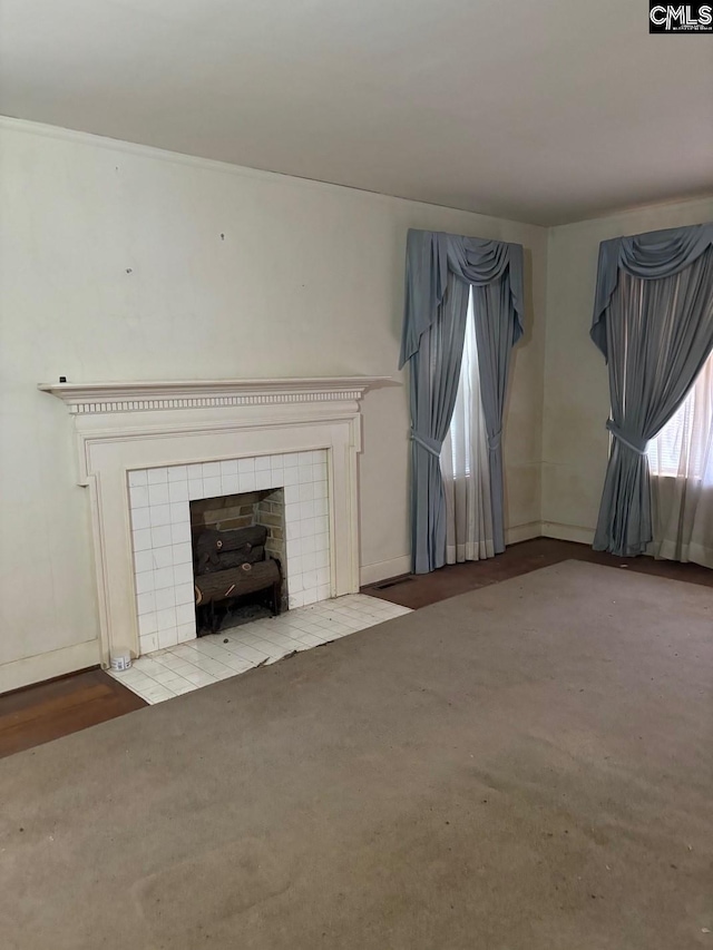 209 E Columbia Ave, Batesburg, SC 29070 - unfurnished living room featuring a tiled fireplace and baseboards