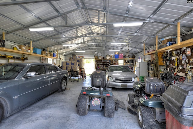 1220 Barnwell Dr, Sumter, SC 29154 - garage featuring metal wall, freestanding refrigerator, and a workshop area