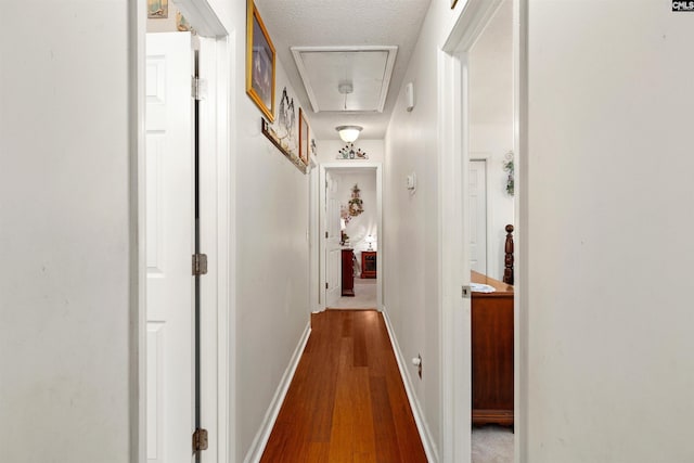 1220 Barnwell Dr, Sumter, SC 29154 - hall with attic access, wood finished floors, and a textured ceiling